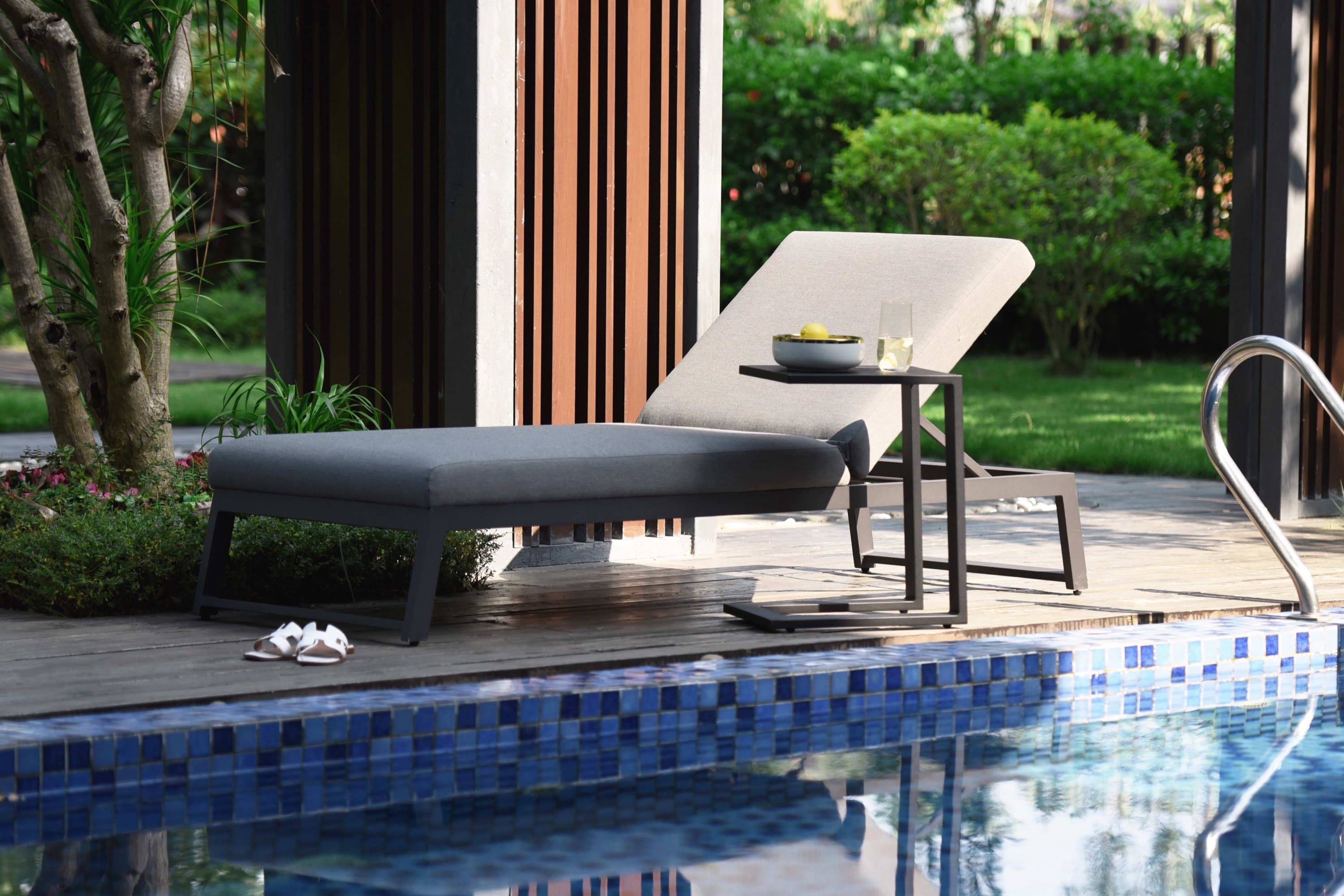 Outdoor sunlounger beside a swimming pool