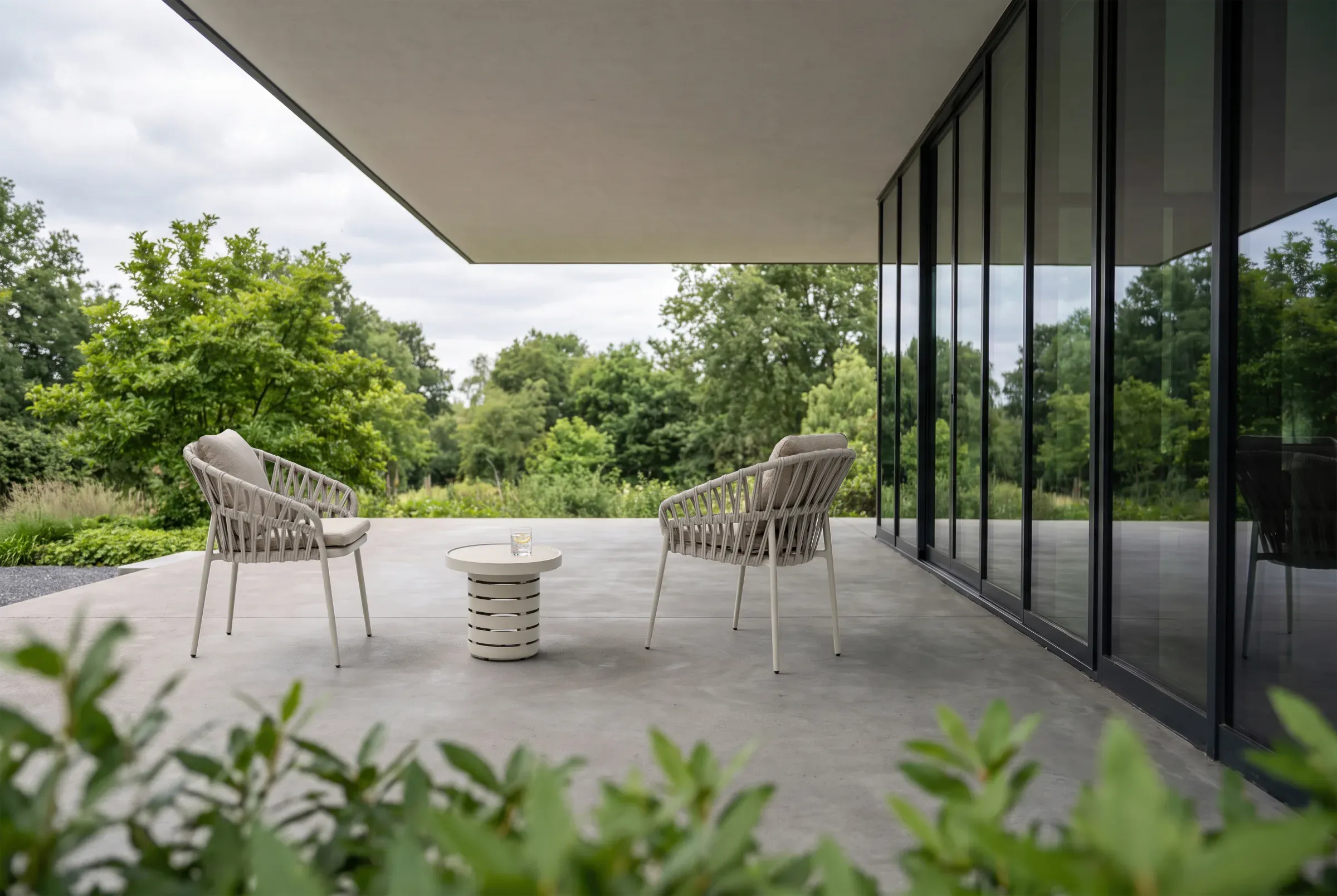 Orbit Round Side Table shown in an outdoor setting